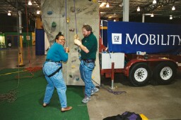 Evelyn Oliver Knight, Total Technology 2002 fair Coordinator, is relieved she has successfully completed her climb on the wall
